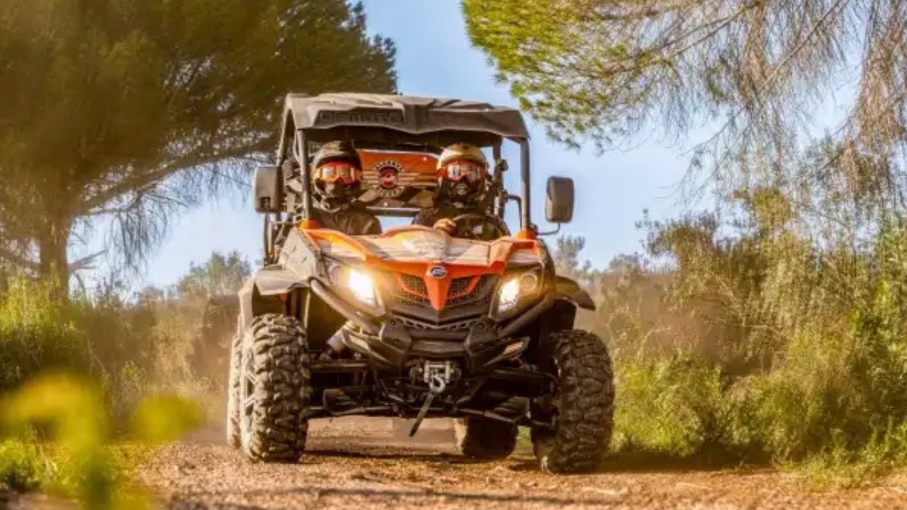 Two people driving a buggy on an off-road trail near Albufeira in the Algarve