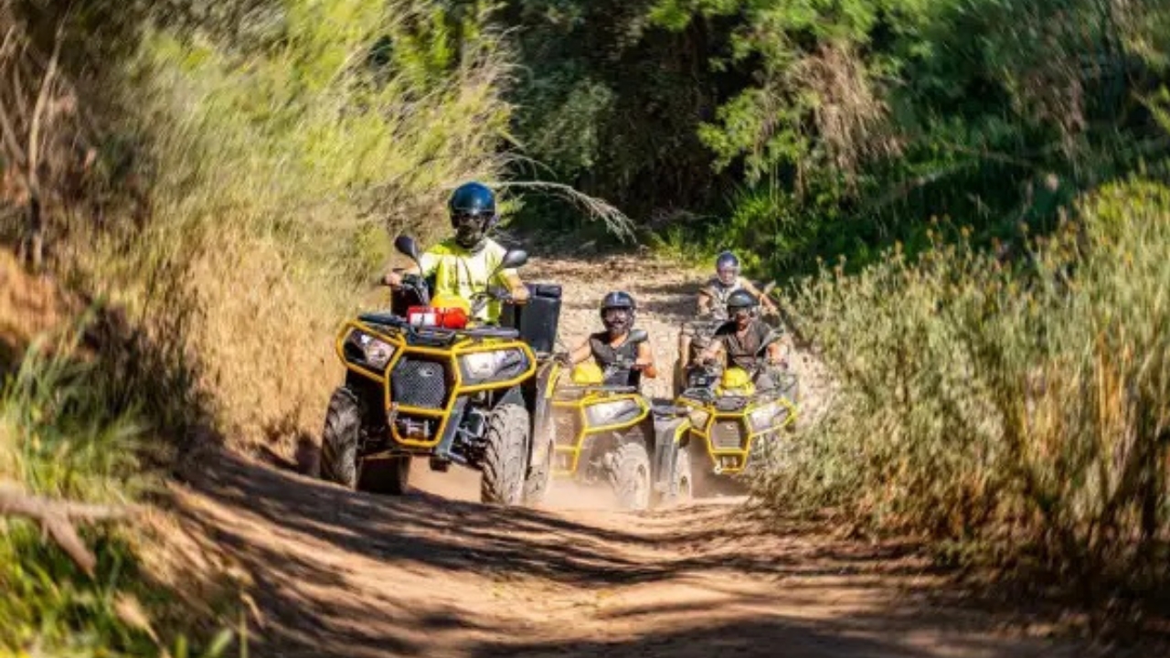 Quad riders exploring an off-road trail through the Algarve countryside near Albufeira